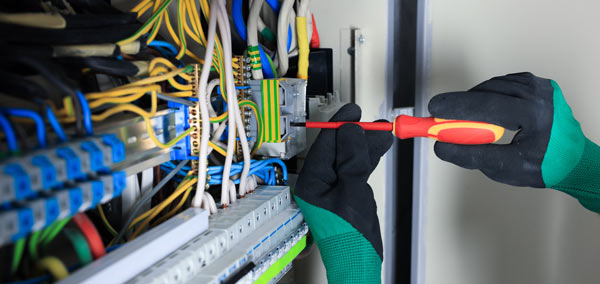 An electrician fixing a fuse board