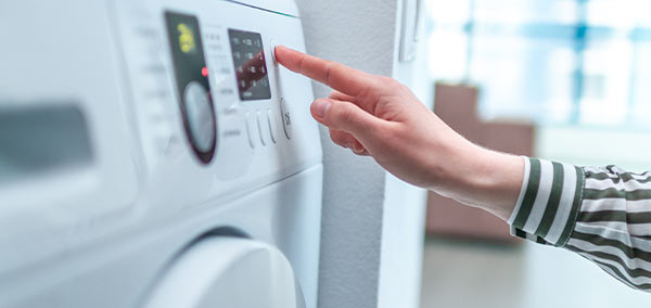 A person using a washing machine