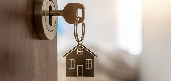 A key with a house key ring