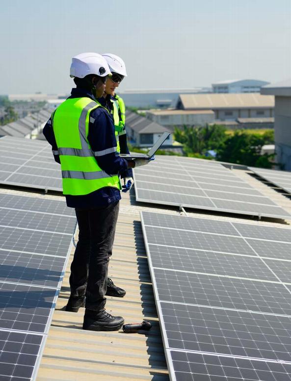 Electricians installing solar panels