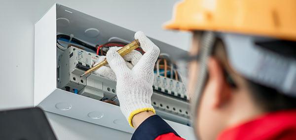 An electrician fixing a fusebox